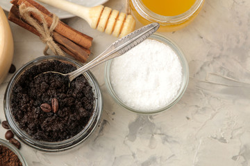 homemade coffee scrub in a jar for the face and body, and various ingredients for making scrub on a light background. spa. cosmetics. care cosmetics. view from above