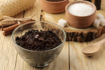 homemade coffee scrub in the face and body bowl and various ingredients for making scrub on a wooden table. spa. cosmetics. care cosmetics.