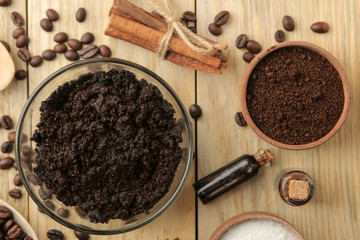 homemade coffee scrub in the face and body bowl and various ingredients for making scrub on a wooden table. spa. cosmetics. care cosmetics. view from above