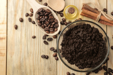 homemade coffee scrub in the face and body bowl and various ingredients for making scrub on a wooden table. spa. cosmetics. care cosmetics. top view with space for text
