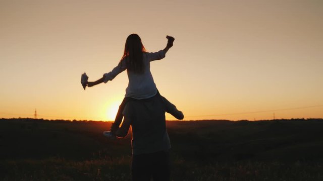Happy father playing with his daughter at sunset. video