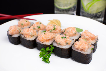 Salmon fish Sakemaki in a plate on a restaurante table seen