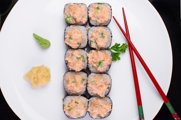 Salmon fish Sakemaki in a plate on a restaurante table seen from above