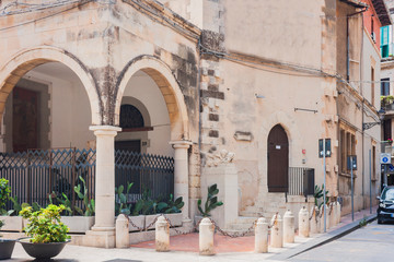 Fototapeta na wymiar Travel to Italy - historical street of Syracuse, Sicily, facade of ancient buildings