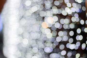 Christmas background with natural bokeh lights. Blurry facade with garlands