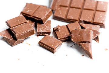 chocolate bar, shavings and cookies on a table