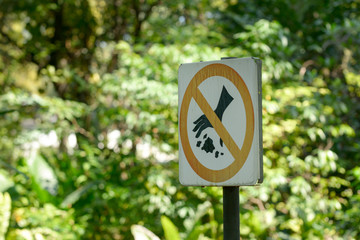Sign board No littering in public park.