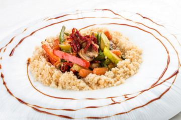 Wok vegetables in coconut milk with couscous. Vegetarian dish. On white background