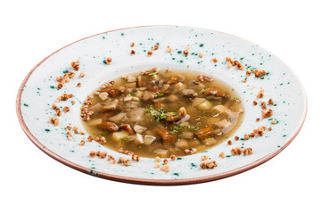 Soup with white mushrooms and buckwheat. Vegetarian dish. On white background.
