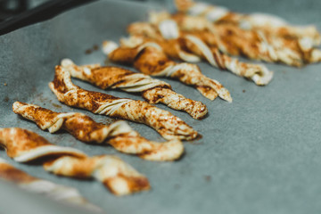 Spun puff pastry cookies on a baking sheet - home recipes