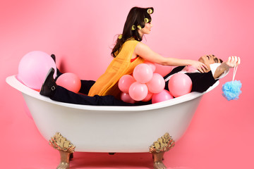 Hair grooming routine. Bathing hygiene habits. Couple in bath tub. Couple of mime man and sexy...