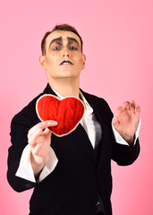 Serious about someone. Love confession on valentines day. Mime man hold red heart for valentines...