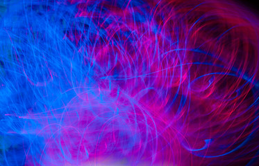 Fototapeta na wymiar Defocused colored luminous spots and curved lines. For background