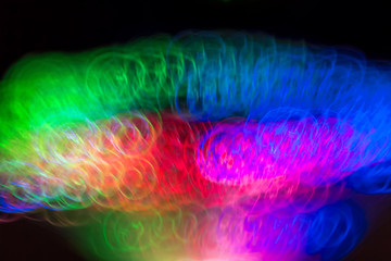 Defocused colored luminous spots and curved lines. For background