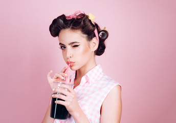 pretty girl in vintage style. pin up woman with trendy makeup. pinup girl with fashion hair. perfect housewife. retro woman drink summer cocktail. Having fun