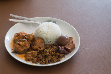 Rice with Eggs and pork in brown sauce and curry fish
