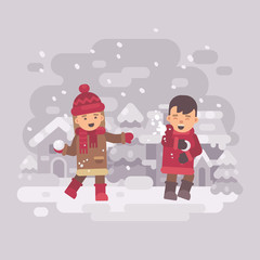 Two cute kids playing snowballs in a winter village