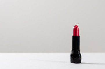 Red lipstick on white background. Copy space