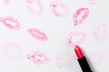 Obraz premium Lipstick kisses and lipstick tube on white background. St. Valentin's day concept. Copy space