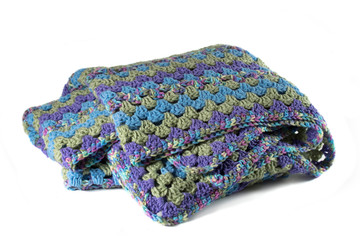 Purple, Blue and Green Variegated Crochet Afghan Throw Blanket isolated on a white background