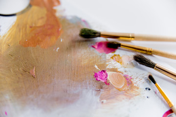 Artistic palette with paint brushes and oil paint