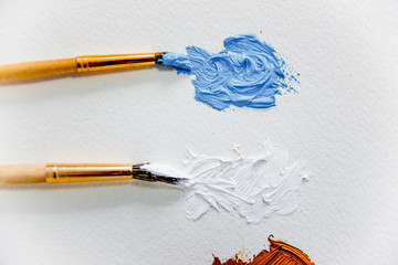 Artistic palette with paint brushes and oil paint