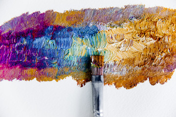 Artistic palette with paint brushes and oil paint