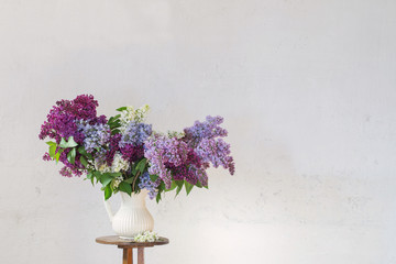 lilac in jug on white backgound