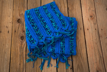Handcrafted Blue Crochet afghan throw blanket on a rustic wood plank background