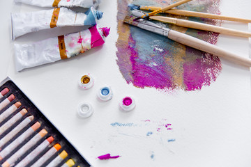 Artistic palette with paint brushes and oil paint