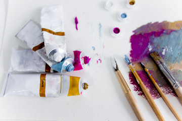 Artistic palette with paint brushes and oil paint