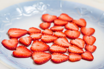 Beautiful heart symbol from chopped red juicy strawberry