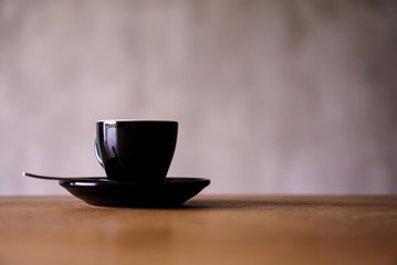 espresso coffee on wood table and vintage texture wall