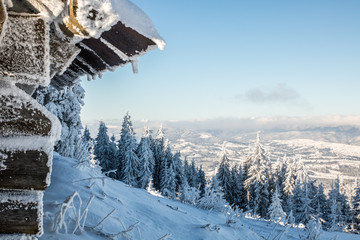winter mountaine landscape from wooden hut in the snowy forest