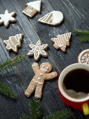 Christmas gingerbread cookies on a wooden table with a Cup of coffee