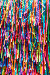 Brightly colored Brazilian wish ribbons in a full frame abstract textured background