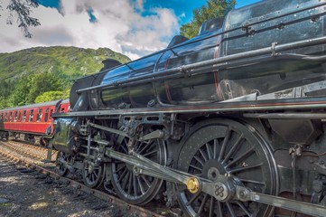 Fototapeta na wymiar A train steaming through the Scottish Highlands