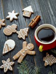 Christmas gingerbread cookies on a wooden table with a Cup of coffee