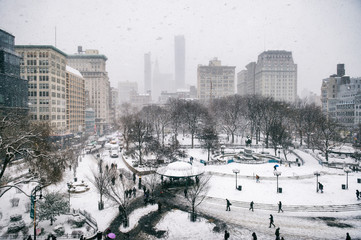 Snowy winter scene with trails left by pedestrians in the snow in Union Square as a blizzard overtakes New York City