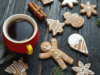 Christmas gingerbread cookies on a wooden table with a Cup of coffee