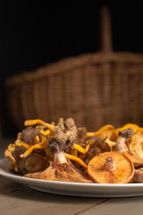 Portrait oriented still-life with wild mushrooms in a rustic wooden table
