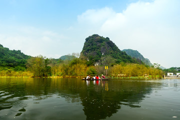 Fototapeta na wymiar Travel by boat in flooded areas submerged trees in YEN stream, Myduc, Hanoi, Vietnam.