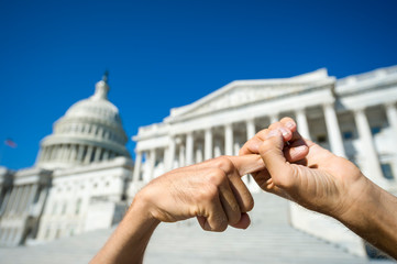 Hands holding of a protestor sending a strong message in front of the Capitol Building in...