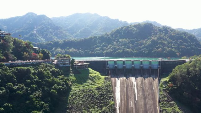 Aerial view of Shimen Reservoir spillway and dam, mountain surrounding, Taiwan, Asia.