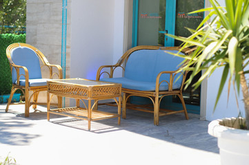 Furniture for the outside site. Palm trees. Patio. Summer. The sun