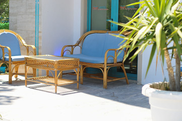 Furniture for the outside site. Palm trees. Patio. Summer. The sun