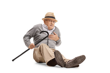 Elderly man on the ground having a heart attack
