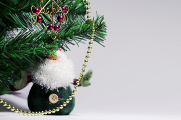 Christmas background with Santa Claus and red forged snowflake. On the Christmas tree hanging...