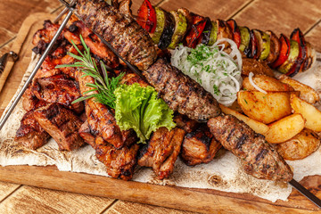 The concept of Georgian cuisine. Meat board with shashlik, grilled pork ribs, lulya kebab and shish...