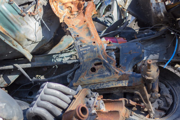 old rusty pile of car wreckage in a landfill